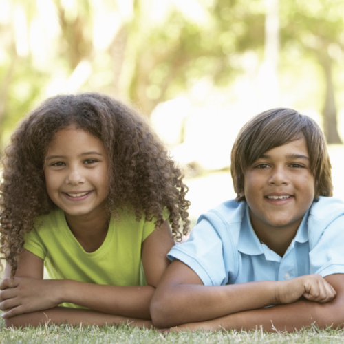 Happy children posing for a photo outdoors.