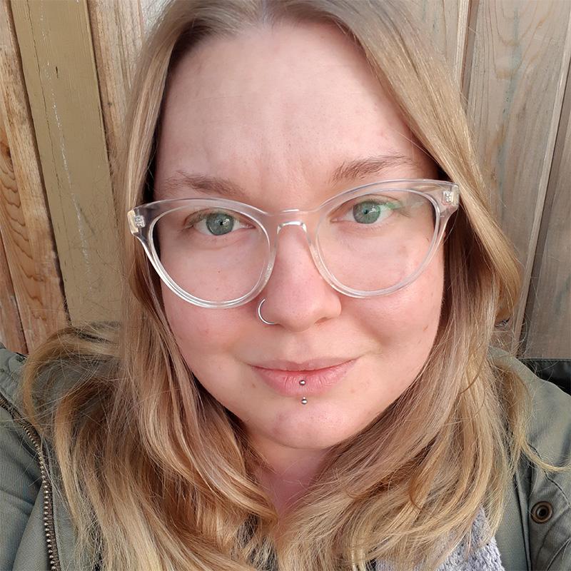 Female CYC student with long hair and glasses.